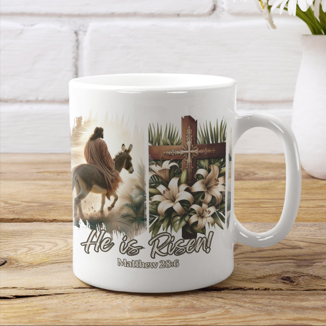 White 15oz Easter Christian coffee mug with a depiction of Jesus riding a donkey, a detailed cross adorned with lilies, and elegant floral touches, all set against a dramatic black brushstroke backdrop. Also features the words He is Risen! and the Bible verse Matthew 28:6 at the bottom of the mug.