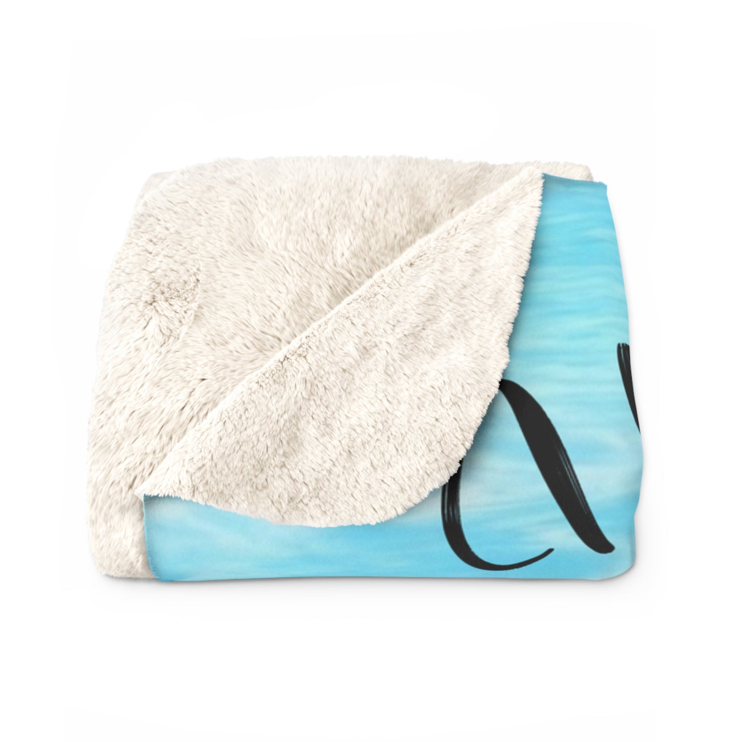 Folded blanket with white sherpa side showing and blue patterned side on a white background.