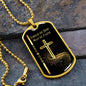 Gold Child of God Man of Faith dog tag necklace with gold cross and black background and gold ball chain positioned on gray rock.