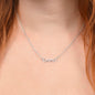American Stainless Steel custom name necklace being warn by a red head young lady. Close up of models neck reveals the name "Emma." Name featured here is 'Imani." Supports up to 8 characters for the name necklace. Name height measures 0.3".