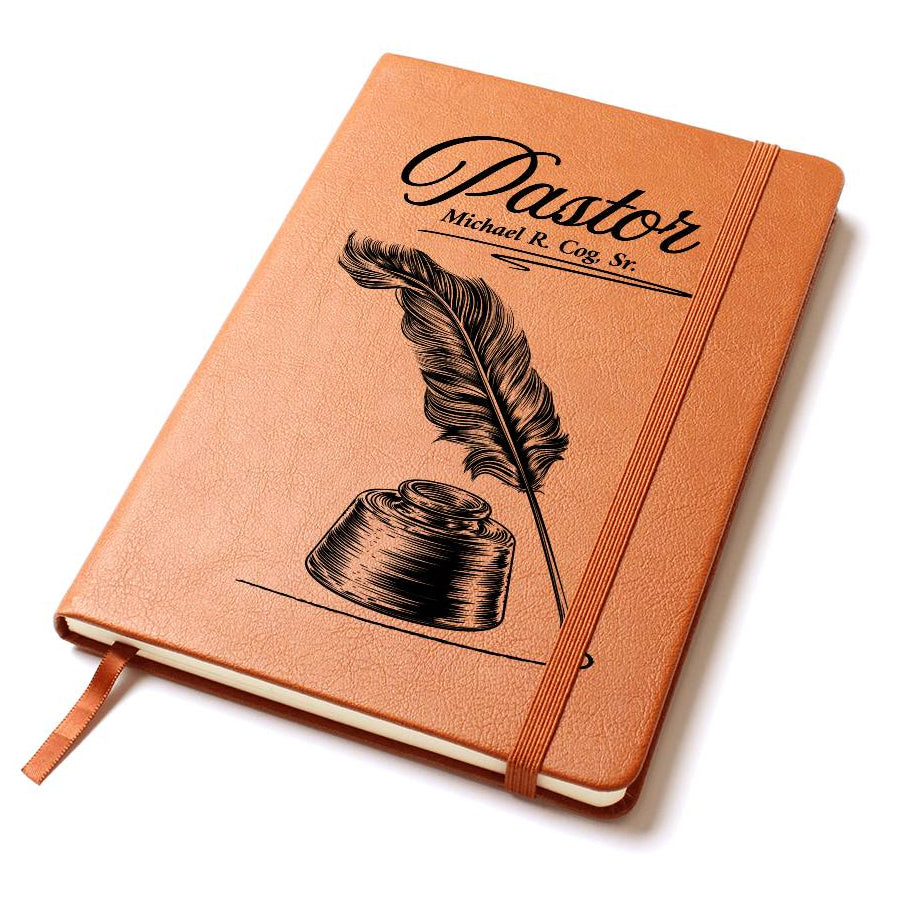 A brown journal notebook with a feather and inkwell illustration printed in black on the cover. Personalization available for the pastor's name.