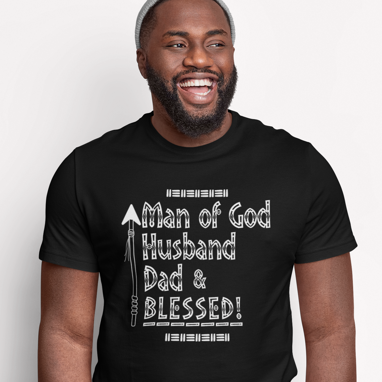 Man wearing a black Christian t-shirt with text on a white background that reads Man of God Husband Dad & Blessed!
