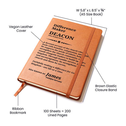 A lined notebook shown on a white background with callout labels pointing to its vegan leather cover, brown elastic closure band, ribbon bookmark, and printed cover text. The notebook is tan/caramel brown with black text and appears to be an A5 size book.