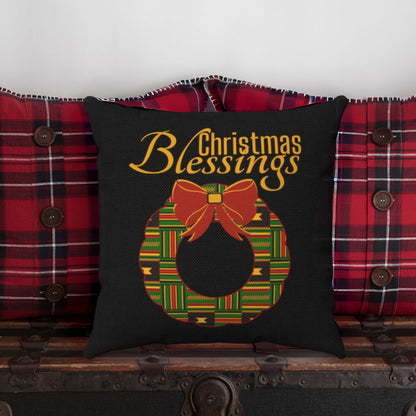 Decorative pillow with 'Christmas Blessings' text and wreath design on a Kente cloth background.