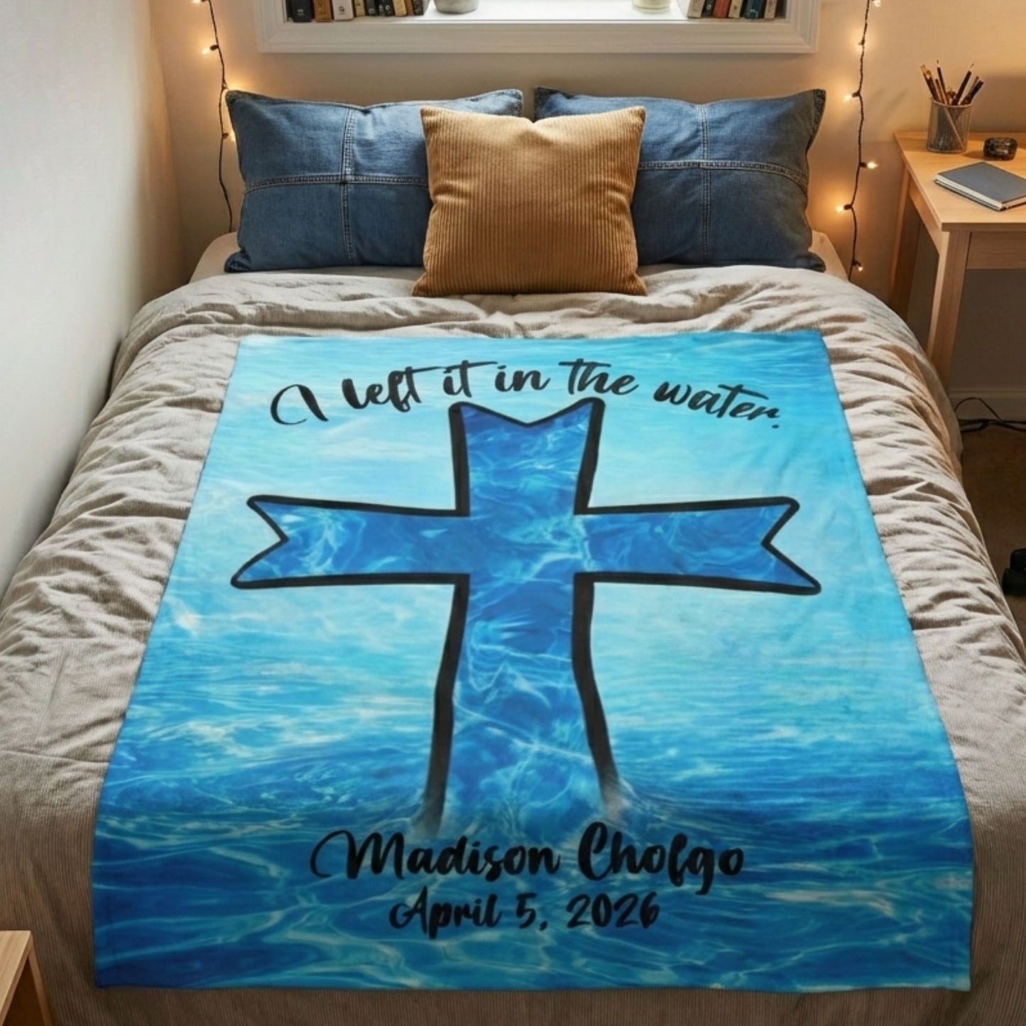 Blanket with a cross design and text on a bed in a bedroom setting