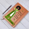 Load image into Gallery viewer, African American Woman dressed in green and white art with Christian quote on the front cover of a light brown vegan writing journal. Christian quote says, &quot;Walking With Jesus daily and living my blessed life.&quot; Also has images of green butterflies and a place at the bottom for personalizing with a name.