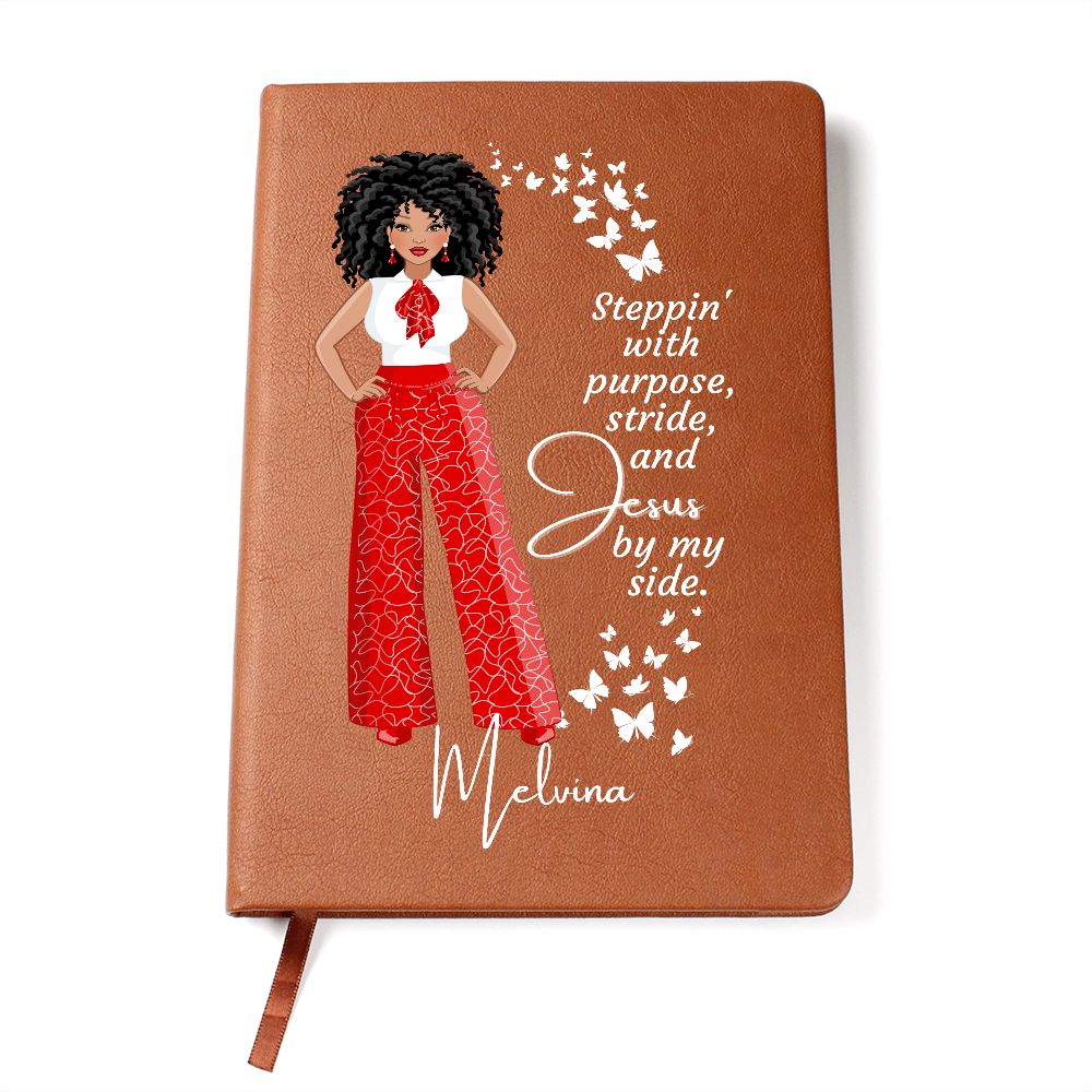 Personalized African American female dressed in red and white pants and shirt on front cover of a vegan leather writing journal. Quote on journal reads: "Steppin' with purpose, stride and Jesus by my side." in a white font. Also has white butterflies on the front cover.