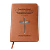 Brown vegan leather writing journal with a silver cross. Includes Bible verse 2 Timothy 4:2 and a place to personalize a name underneath the cross. Bible scripture is printed in black.