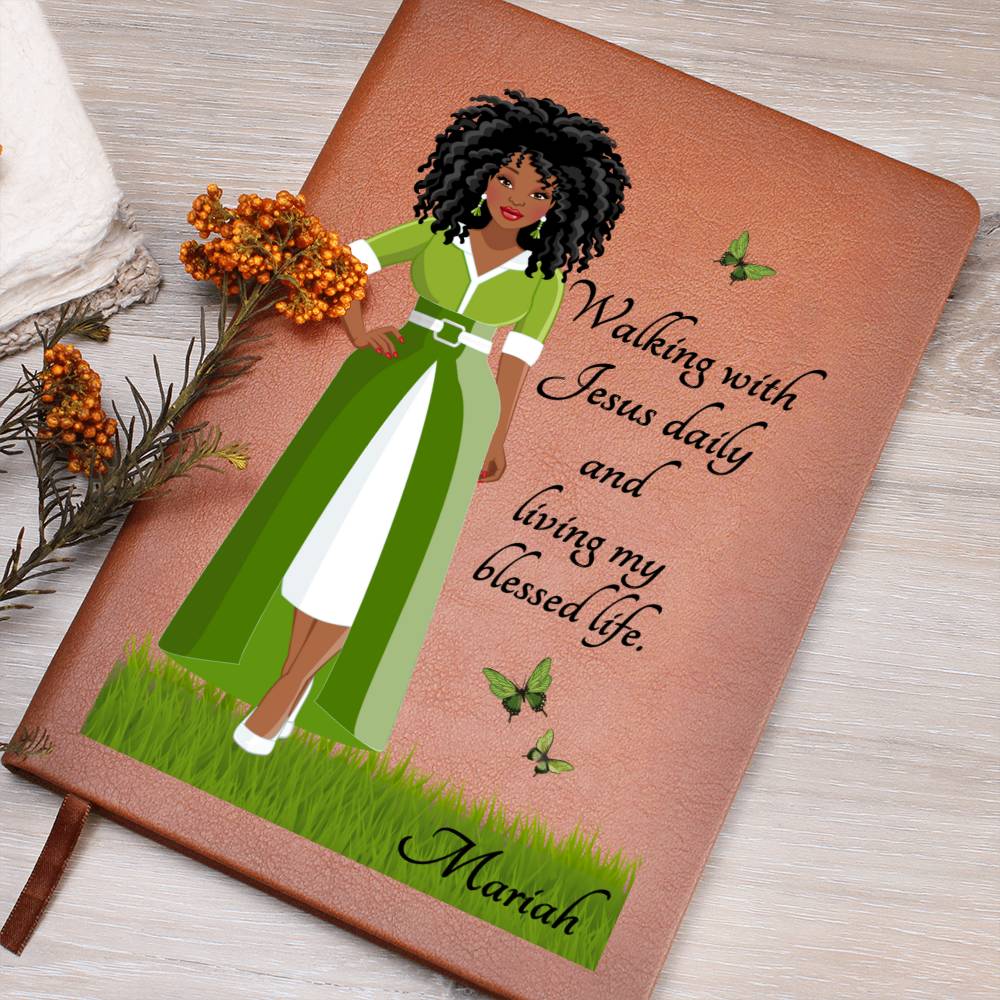 Image of African American Woman with Christian quote on the front cover of a light brown vegan writing journal. Christian quote says, "Walking With Jesus daily and living my blessed life." Also has images of green butterflies and a place at the bottom for personalizing with a name.