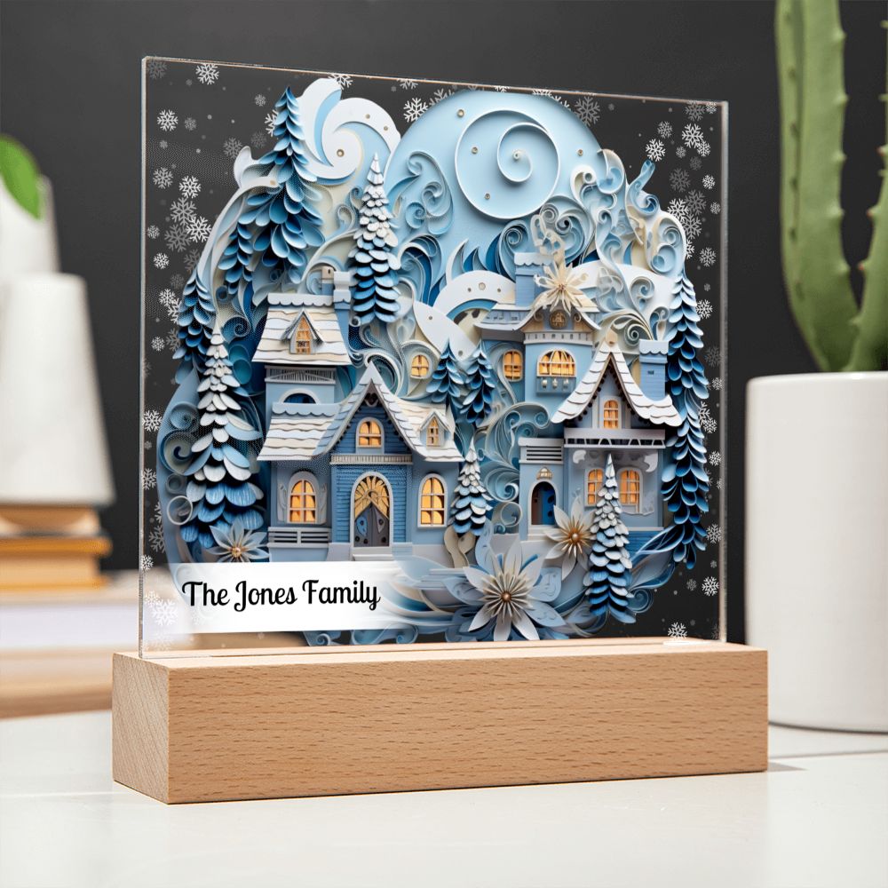 Image of 3D winter village with trees and snow printed on an acrylic plaque that is sitting on wooden base.