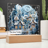 Image of 3D winter village with trees and snow printed on an acrylic plaque that is sitting on wooden base.