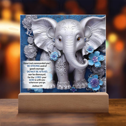 3D silver elephant and flowers on an acrylic plaque. Elephant is in front a beautiful blue background and also features Bible verse Joshua 1:9.
