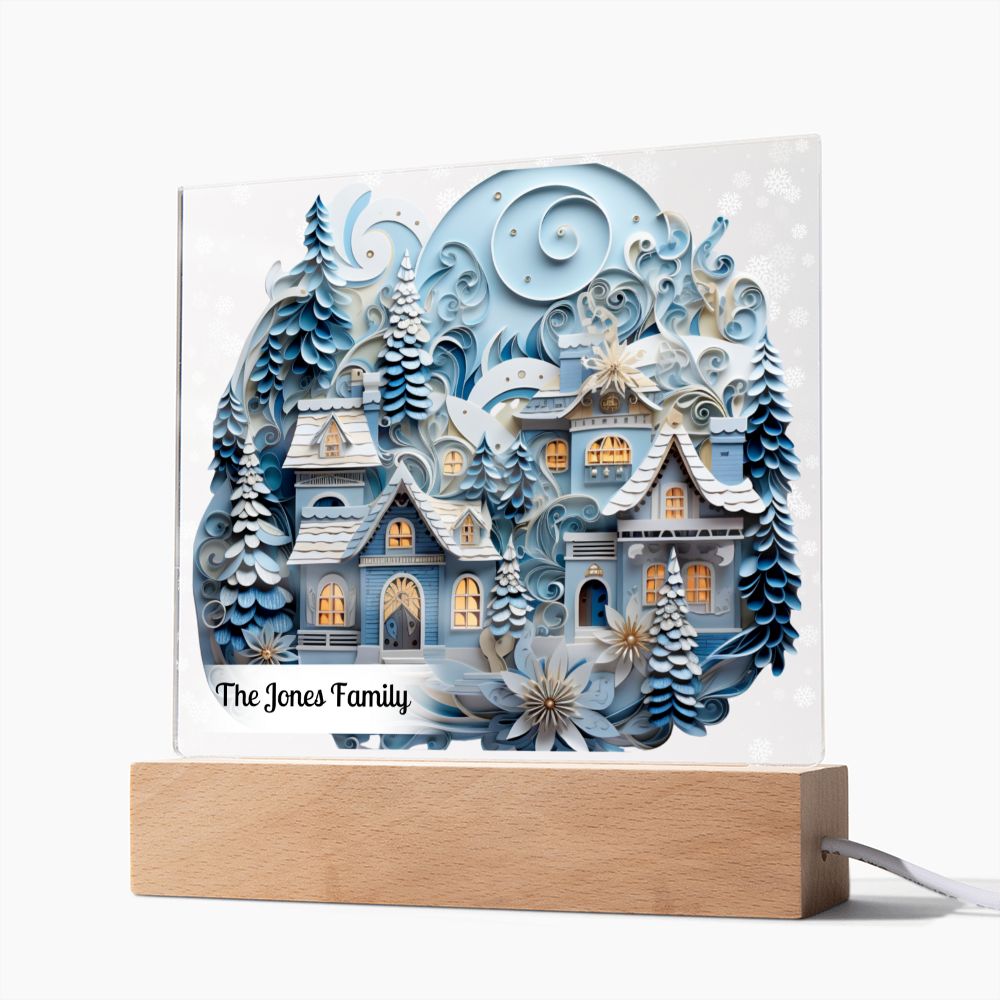 Image of 3D winter village with trees and snow printed on an acrylic plaque that is sitting on wooden LED base.