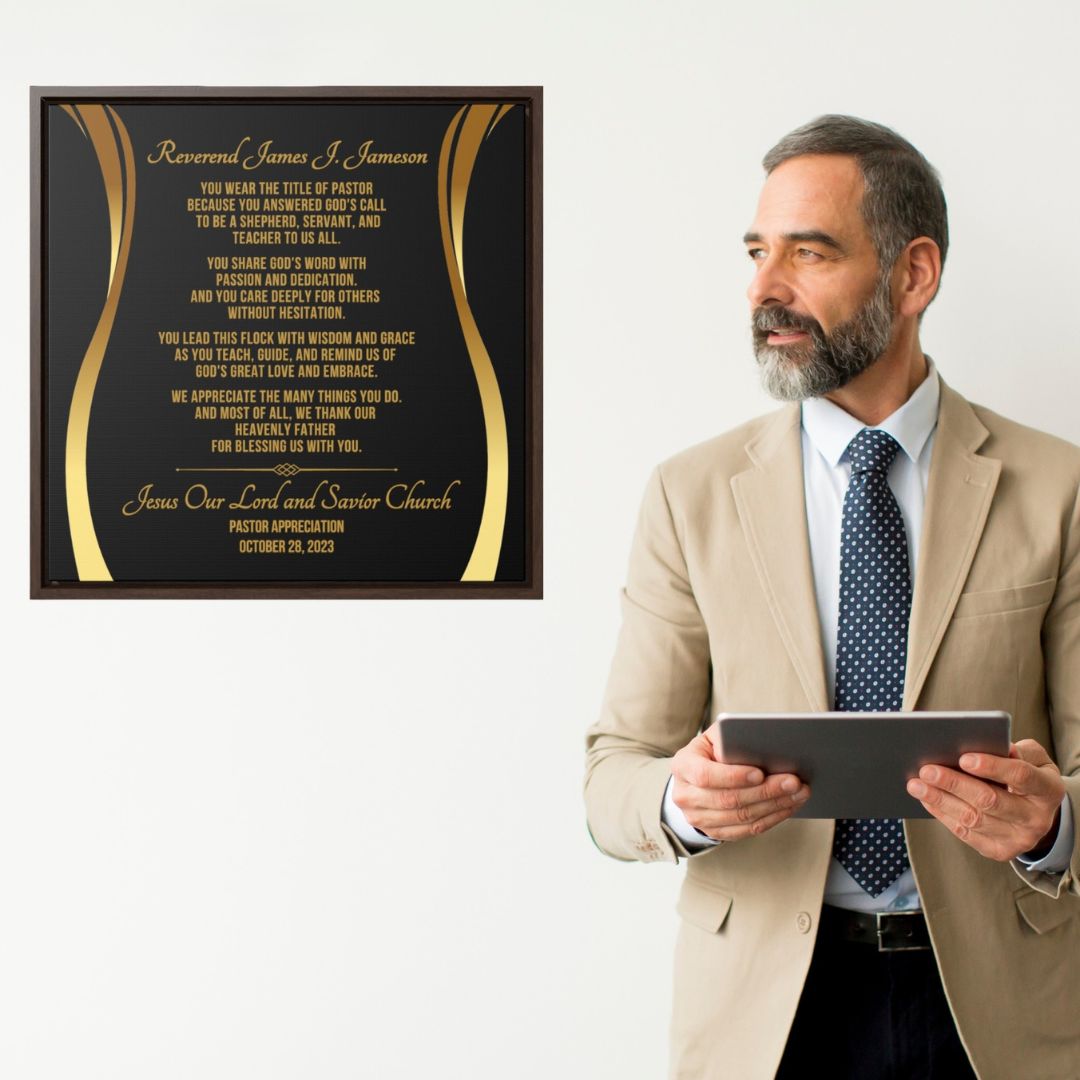 Man in a suit holding a tablet next to a framed plaque with text