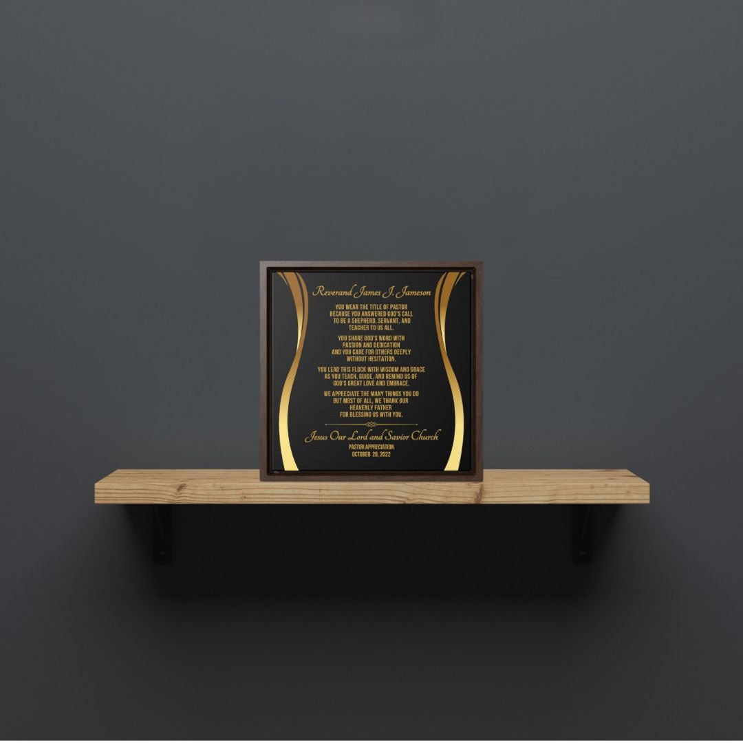 Framed pastor appreciation plaque with gold text on a wooden shelf against a dark gray wall.