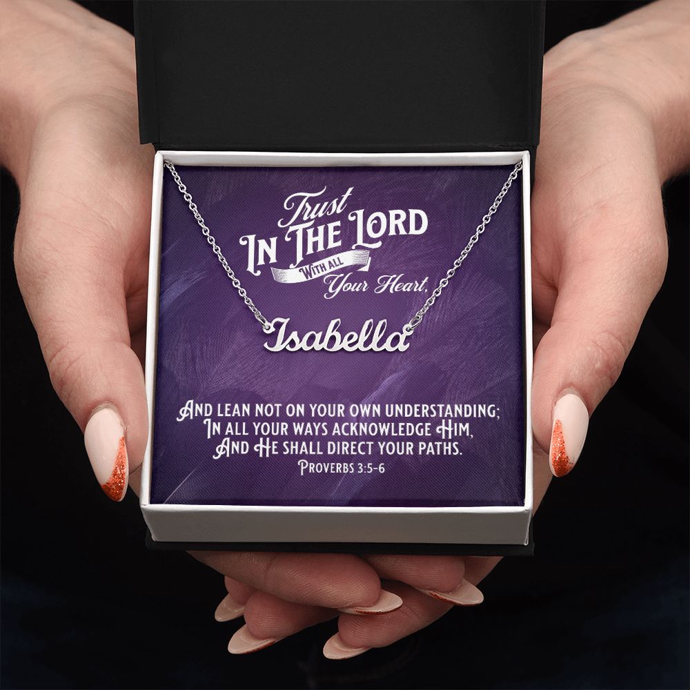 Custom Stainless Steel Name Necklace With Bible Verse Jewelry Message Card. Card features Bible verse Proverbs 3:5-6 - Trust In The Lord With All Your Heart. Image of hands holding a white and black gift box is shown. The card in box has a deep purple background.