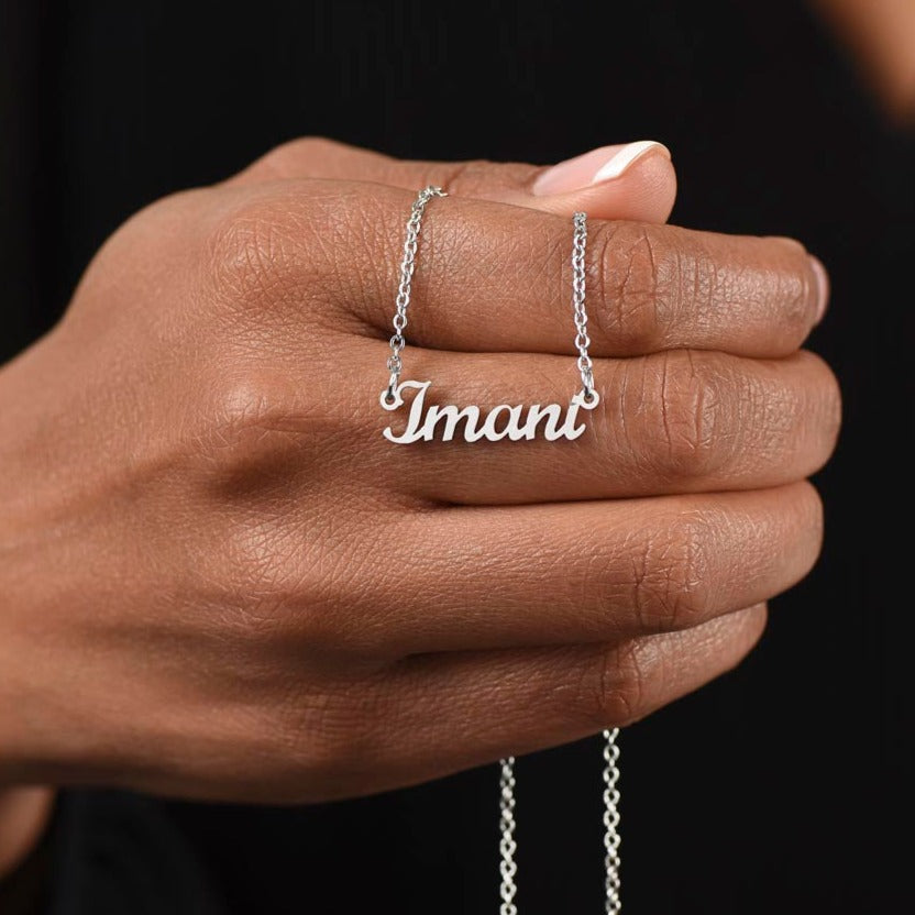 American Stainless Steel custom name necklace with I love you message card. Name featured here is 'Imani." Supports up to 8 characters for the name necklace. Name height measures 0.3".