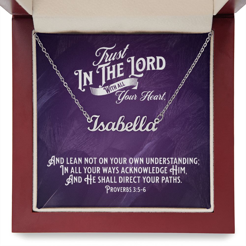 Custom Stainless Steel Name Necklace With Bible Verse Jewelry Message Card. Card features Bible verse Proverbs 3:5-6 - Trust In The Lord With All Your Heart. A closeup of the card in mahogany box has a deep purple background.